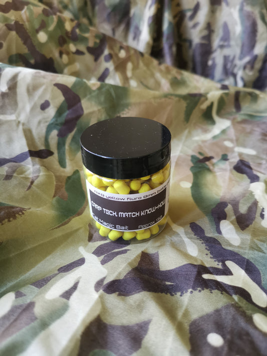 a clear plastic jar of AX8 yellow dumbell shaped baits. label on the side of the jar reads 'AX* yellow fluro 8mm, carp tech, match know-how'